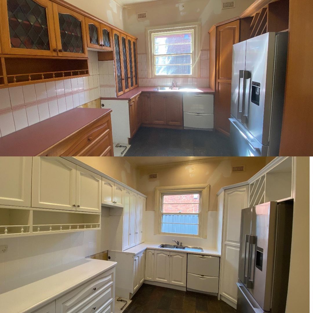 Before and after images of a kitchen showing wooden cabinets and red countertops transformed to white cabinets and countertops.