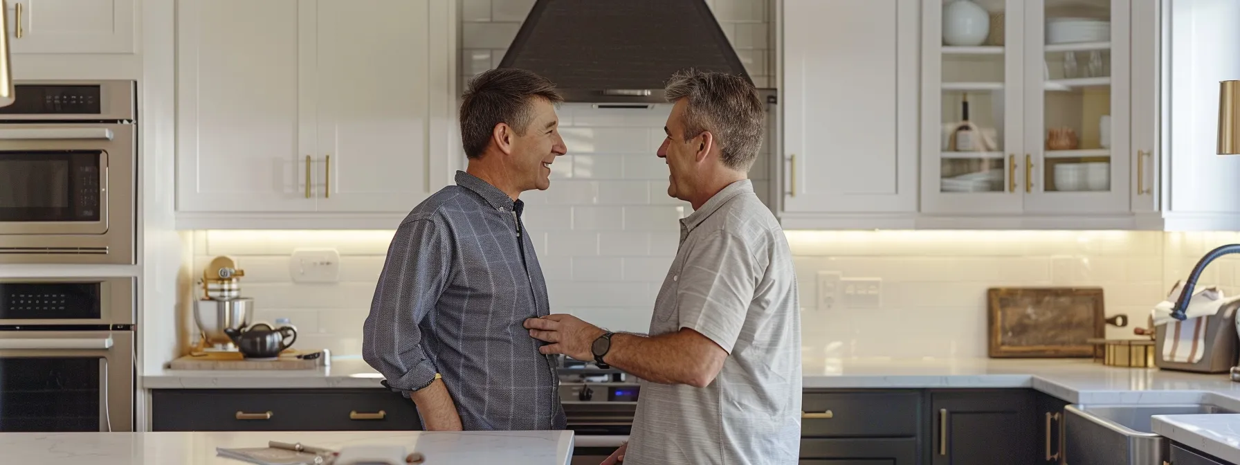 a homeowner standing in a kitchen with a contractor, discussing plans and looking confident in their decision.