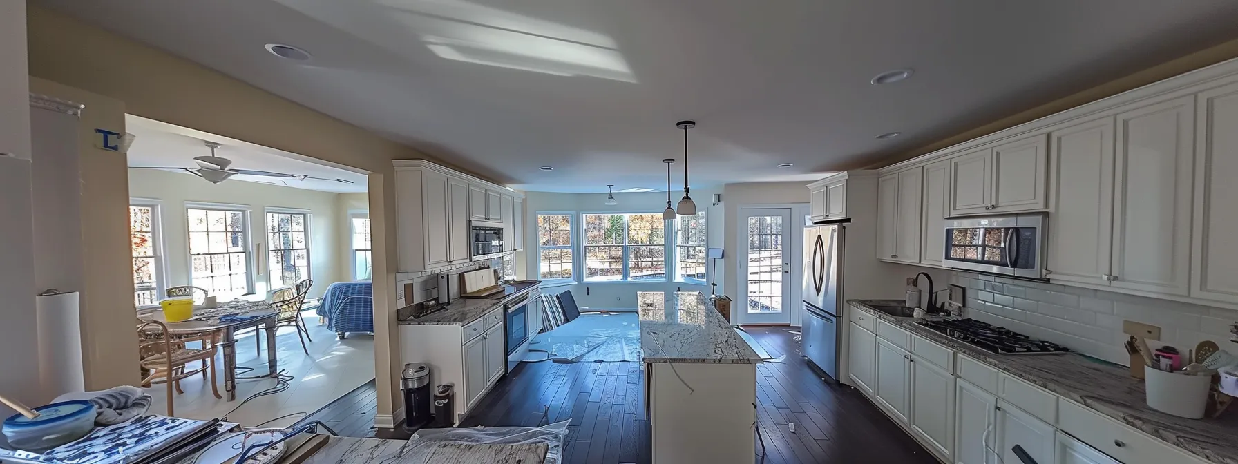 a kitchen with outdated countertops being replaced with new, modern surfaces.