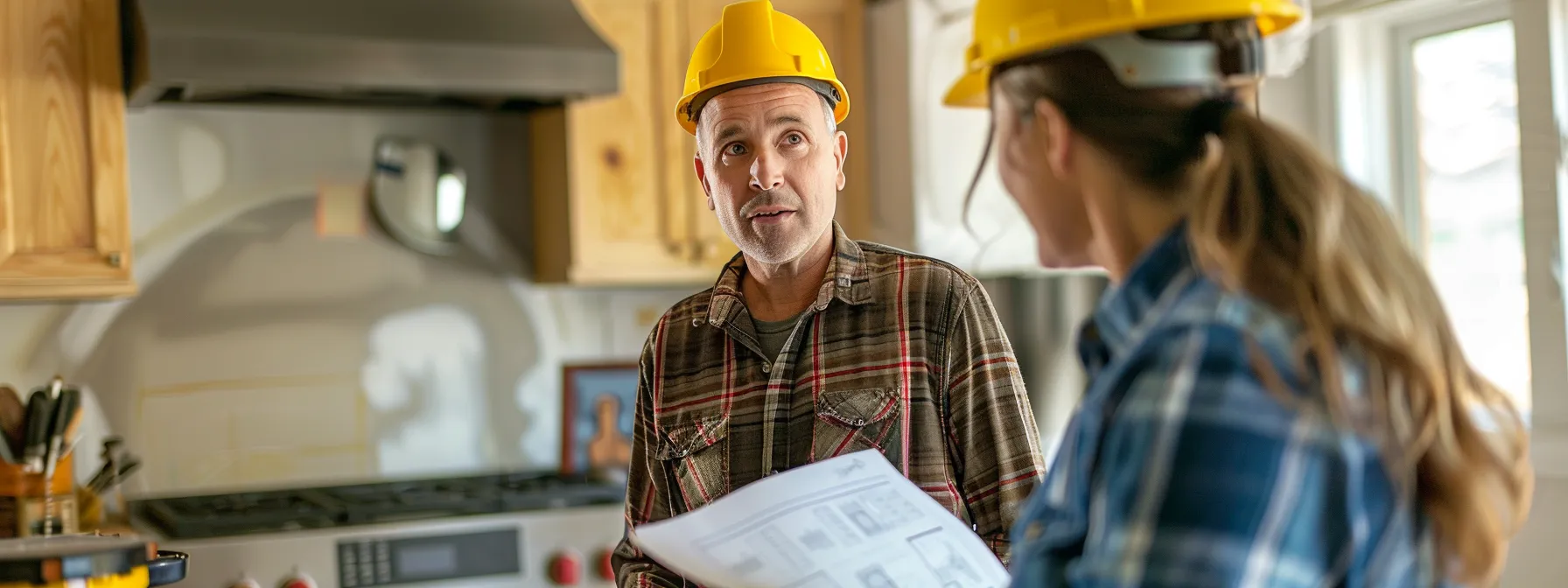 a homeowner speaking with a contractor and looking at renovation project plans.